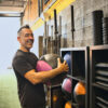 Smiling man holding a medicine ball in gym gym